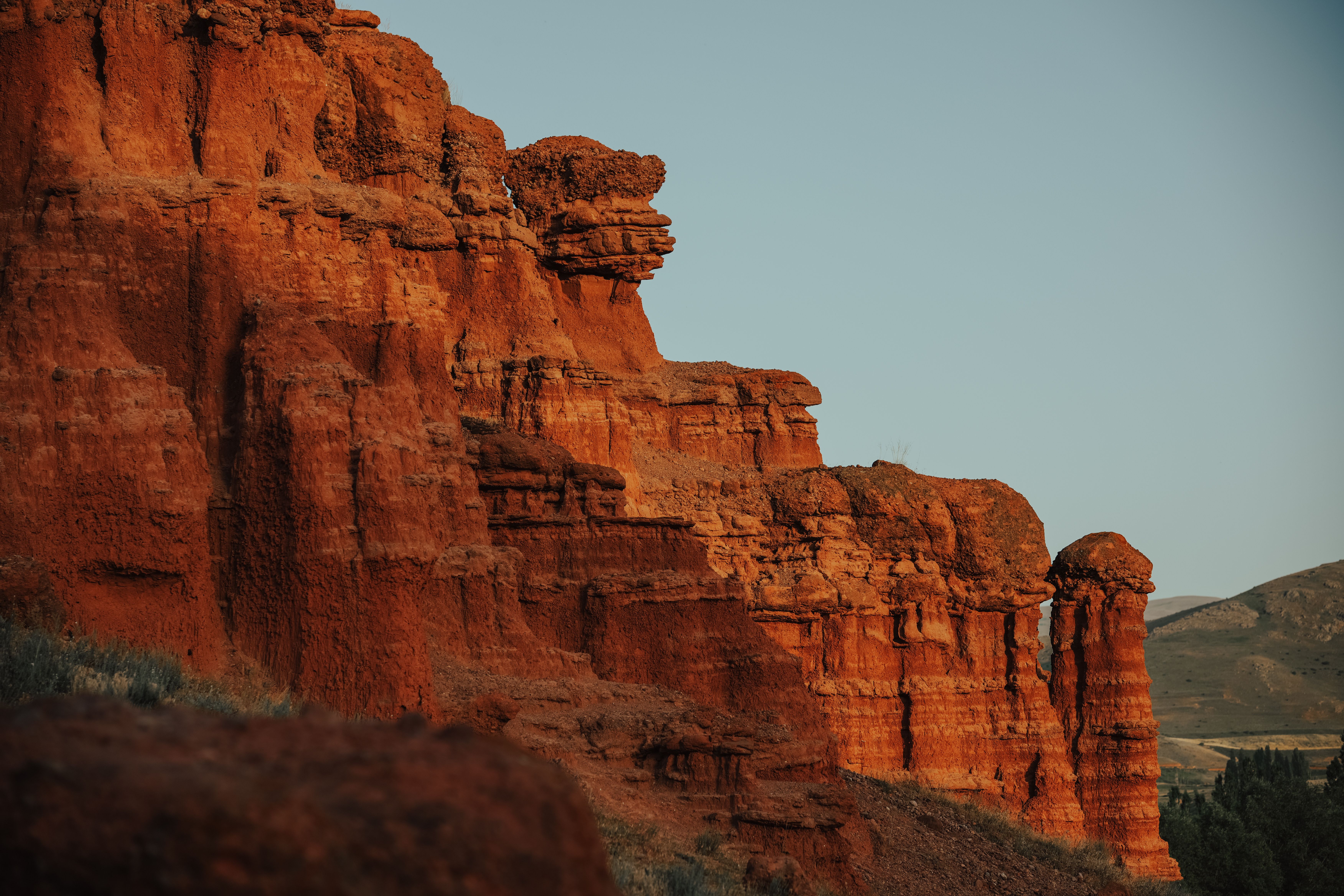 Capture the breathtaking red rock formations of Narman Canyon in Erzurum, Türkiye during sunset.