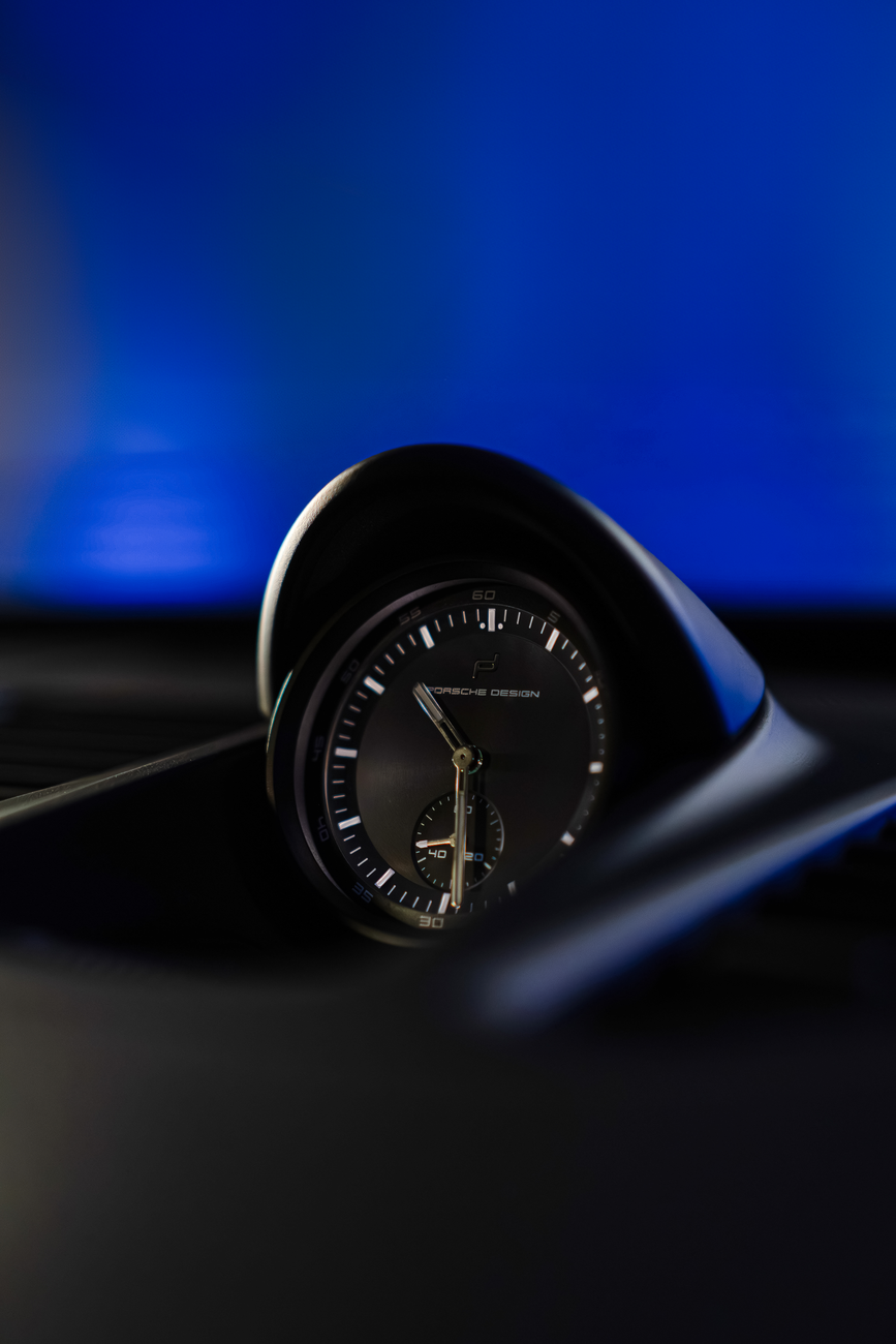 Dashboard clock in a luxury-car cabin, the same design logic Cartier is leaning on with the Roadster