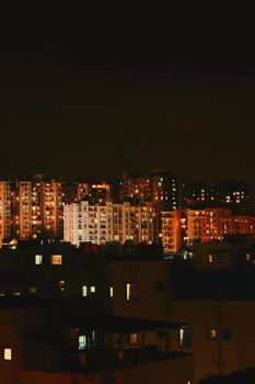 Stunning view of illuminated tall buildings in an urban cityscape at night.