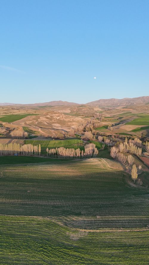 Free Aerial landscape showcasing lush farmland under a clear blue sky in Kayseri, Türkiye. Stock Photo