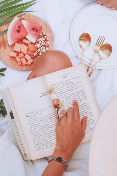 Free Relaxing outdoors with a book and fresh fruit platter on a sunny day, perfect for leisure. Stock Photo