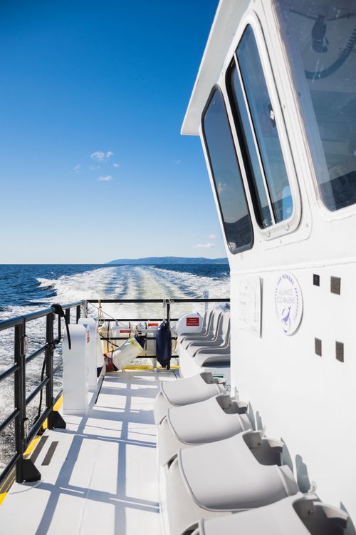 Free View from a boat deck on a sunny day, perfect for summer travel and enjoyment on the ocean. Stock Photo