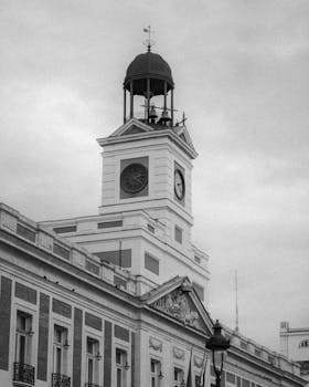 Black and white image of Puerta del Sol's famous clock tower in Madrid, Spain.