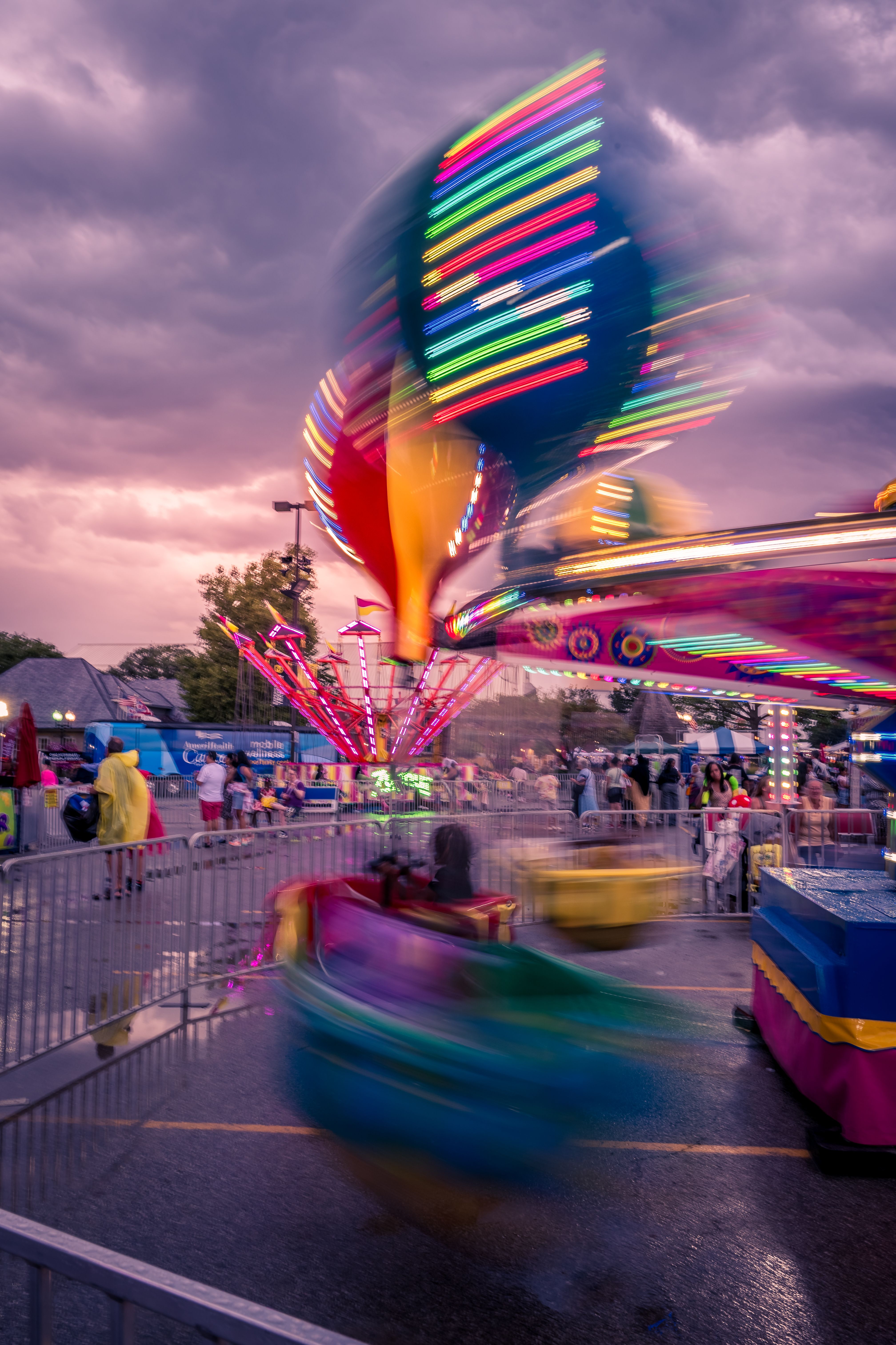 A carnival ride is seen at night with colorful lights · Free Stock Photo