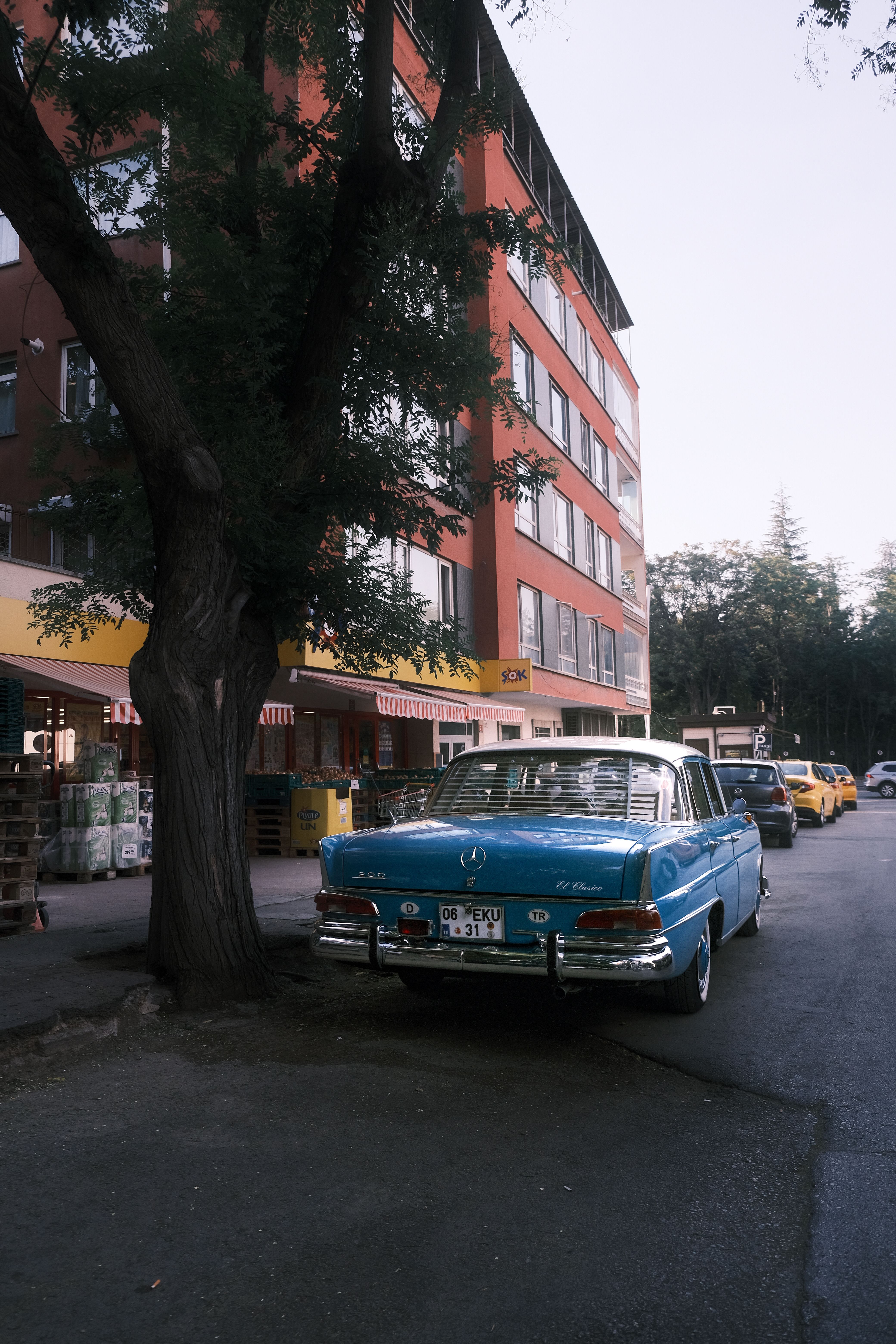 A blue car parked on the side of a street · Free Stock Photo