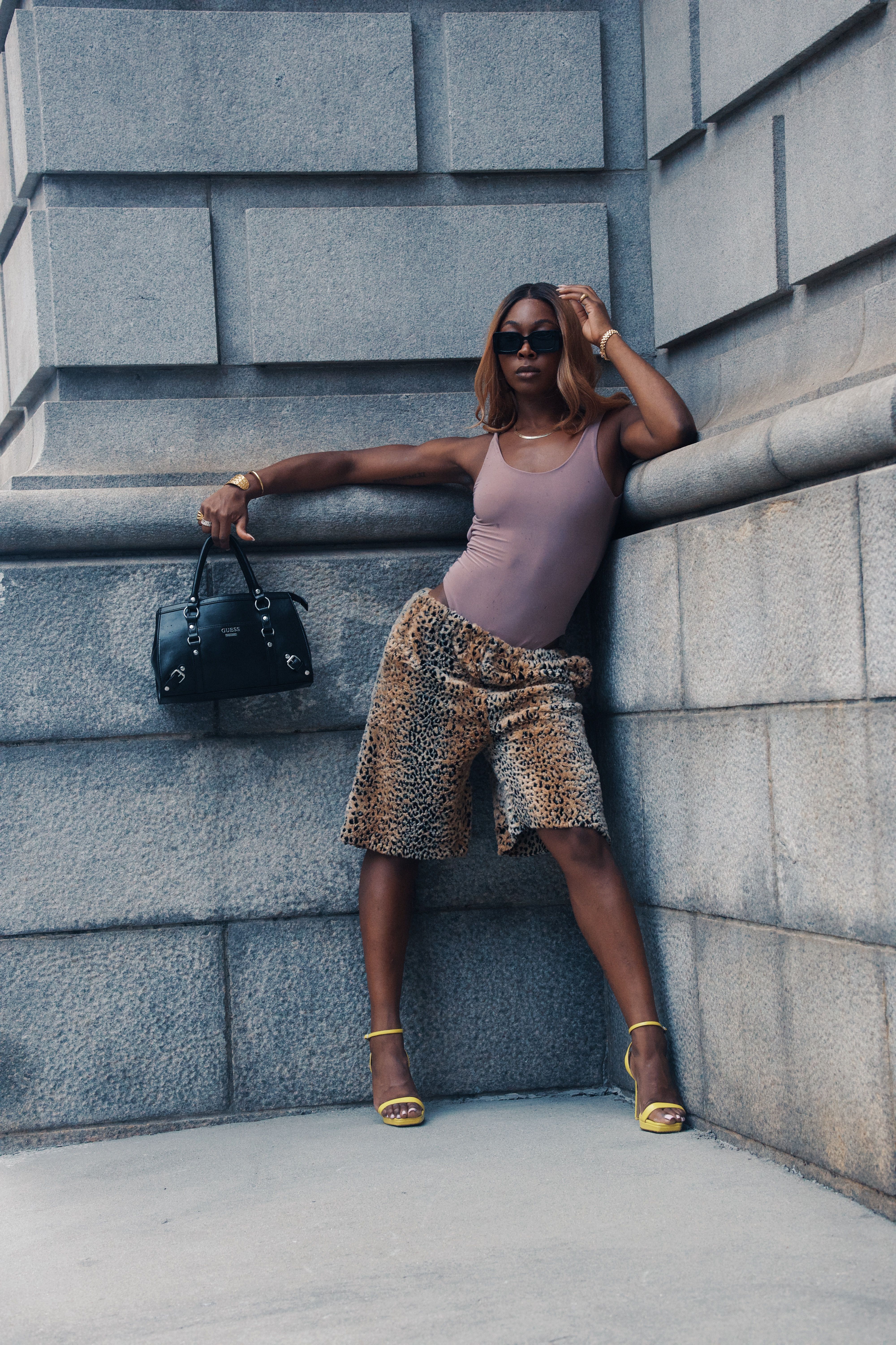 black-fashion-model-posing-with-a-black-purse-free-stock-photo