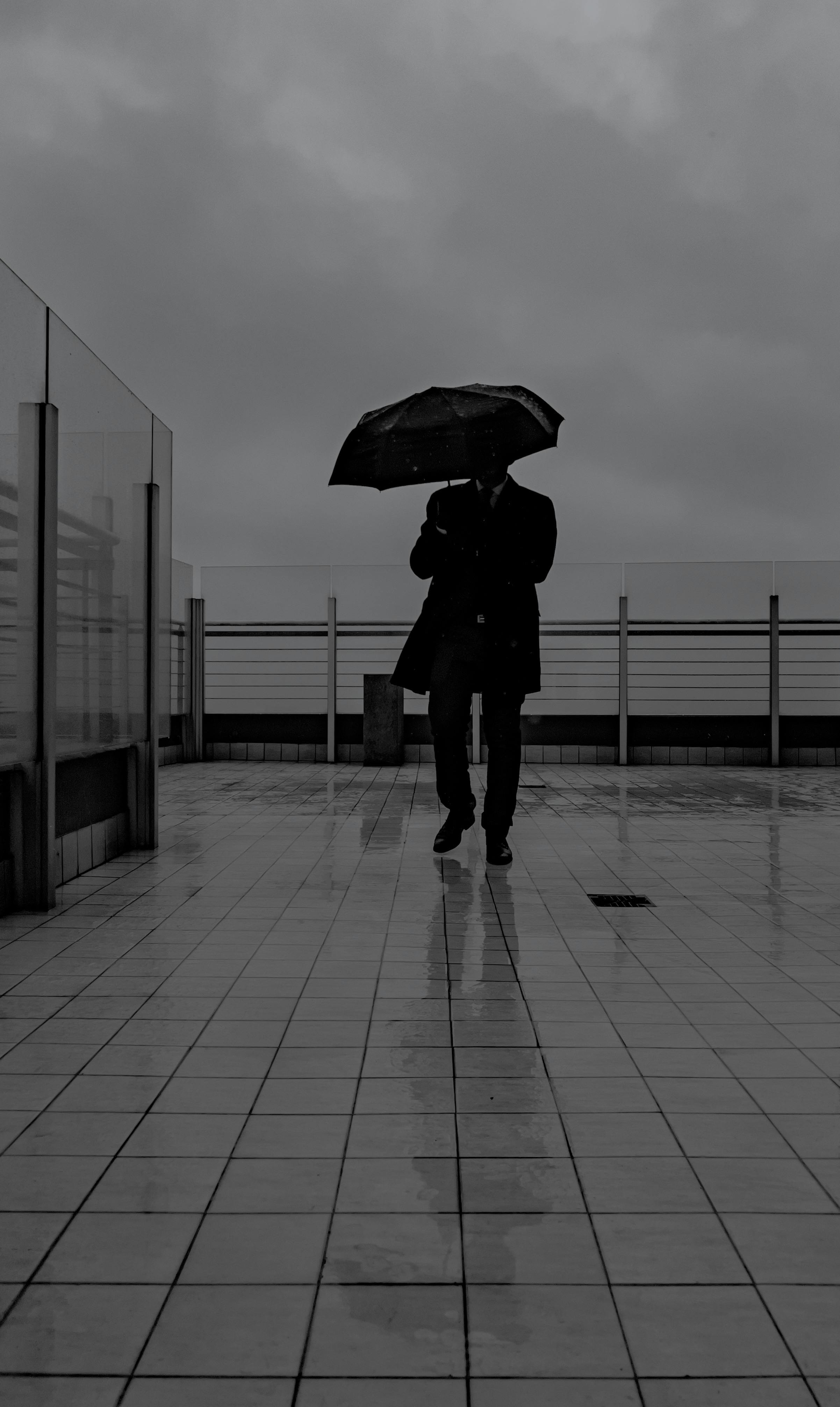 a person walking in the rain with an umbrella