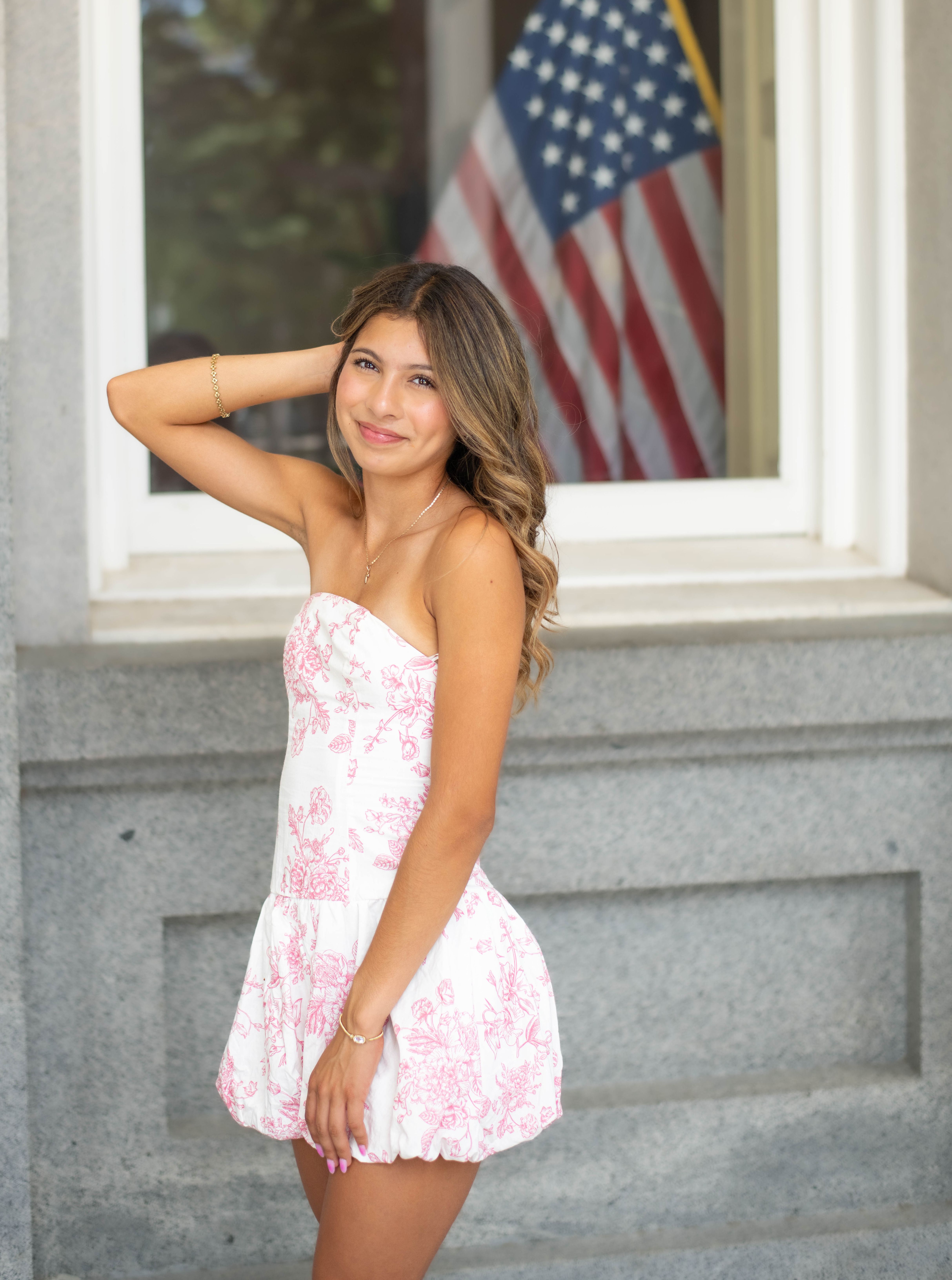 A young woman posing in front of an american flag · Free Stock Photo