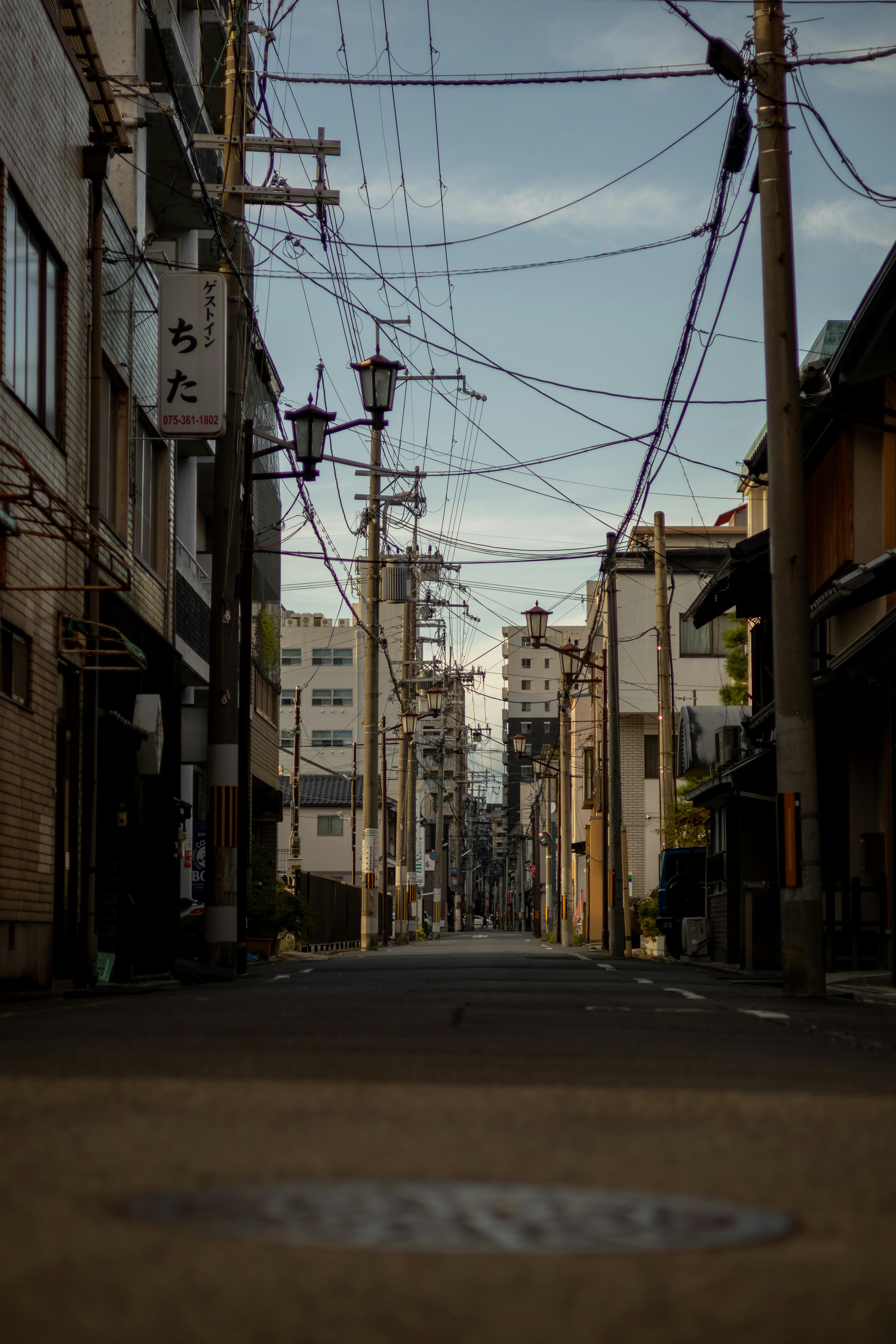 a street with power lines and telephone poles