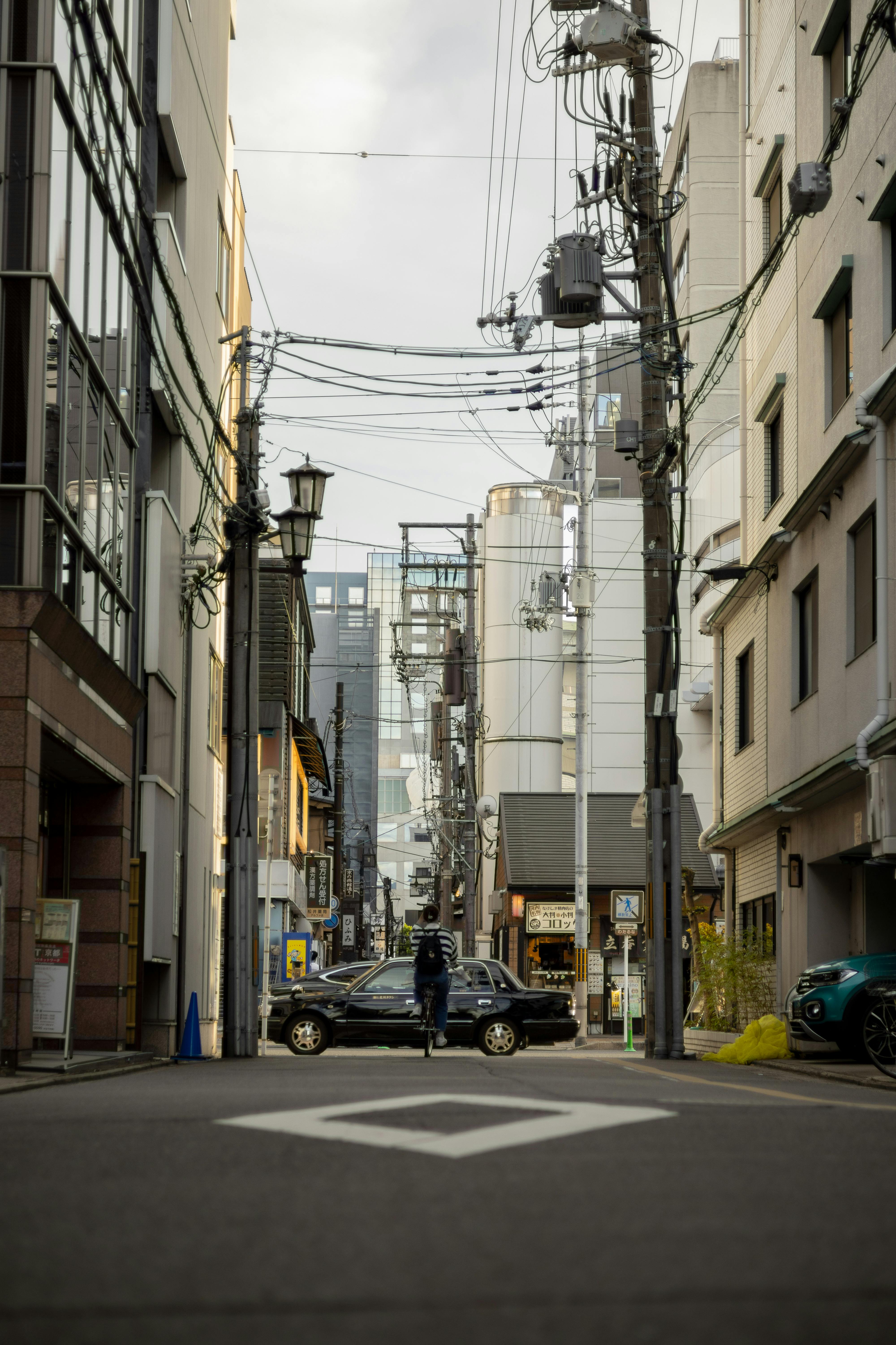 a person is walking down a narrow street