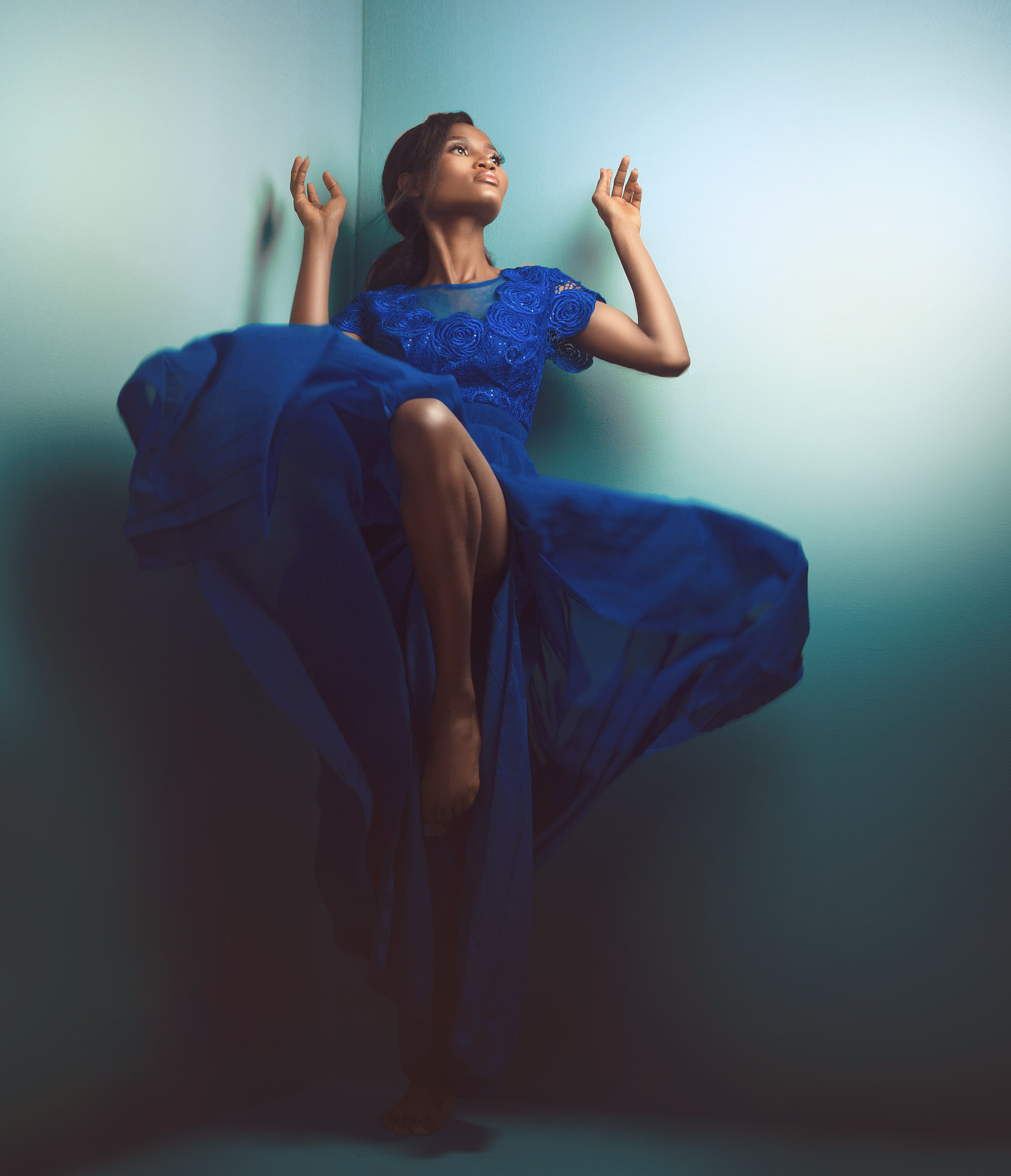A woman in a blue dress is posing  Free Stock Photo