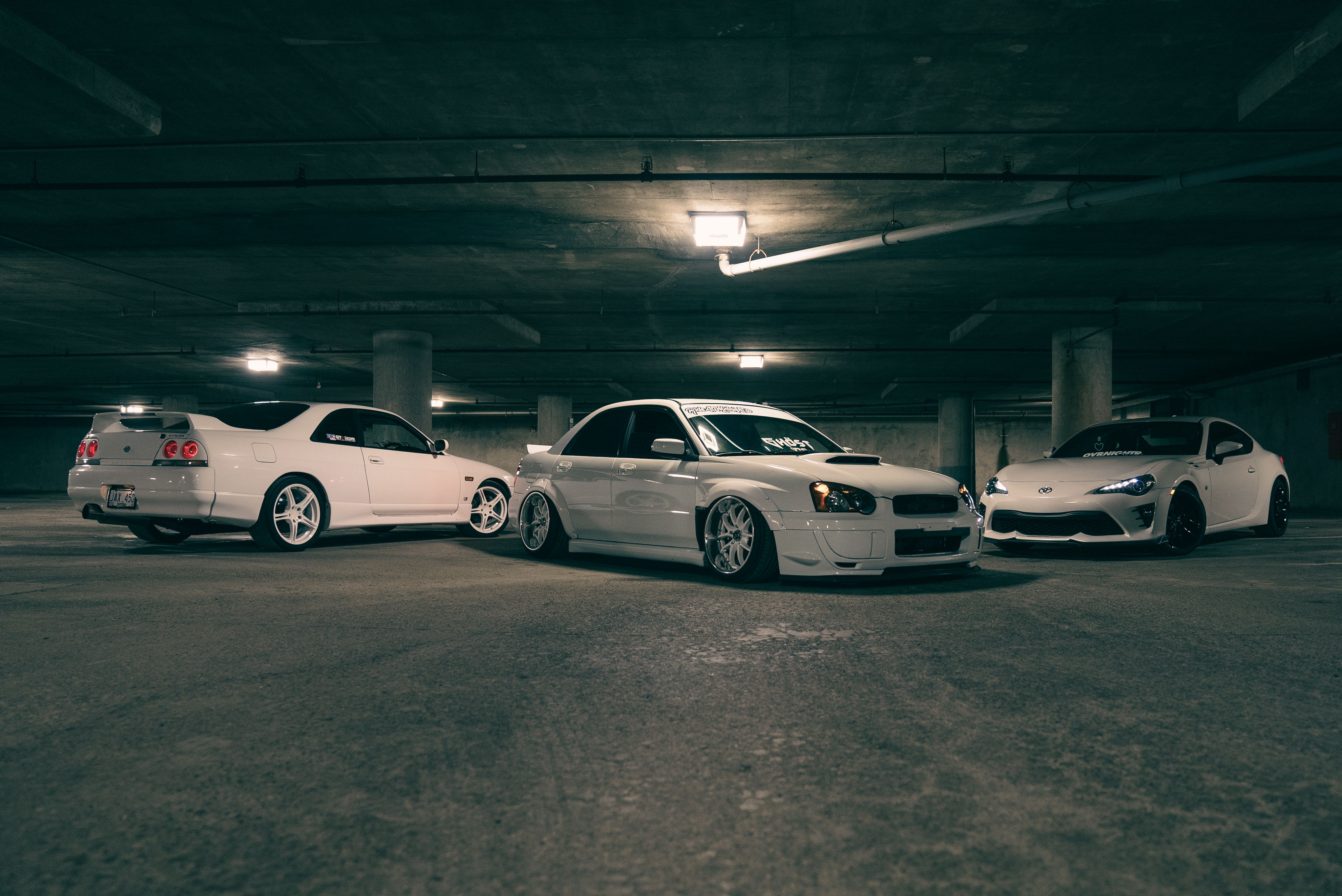 Three cars parked in a parking garage · Free Stock Photo