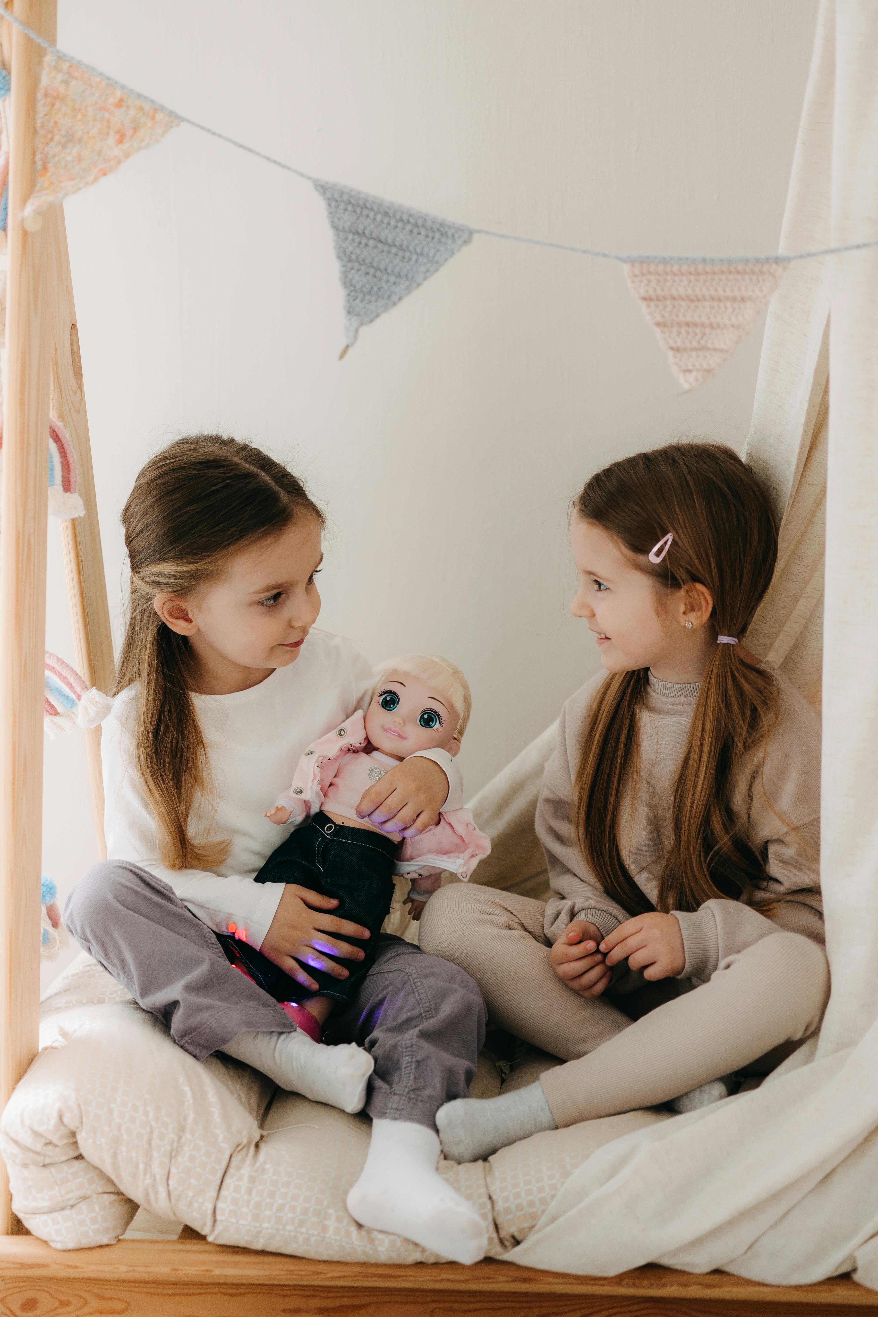 children sitting with doll