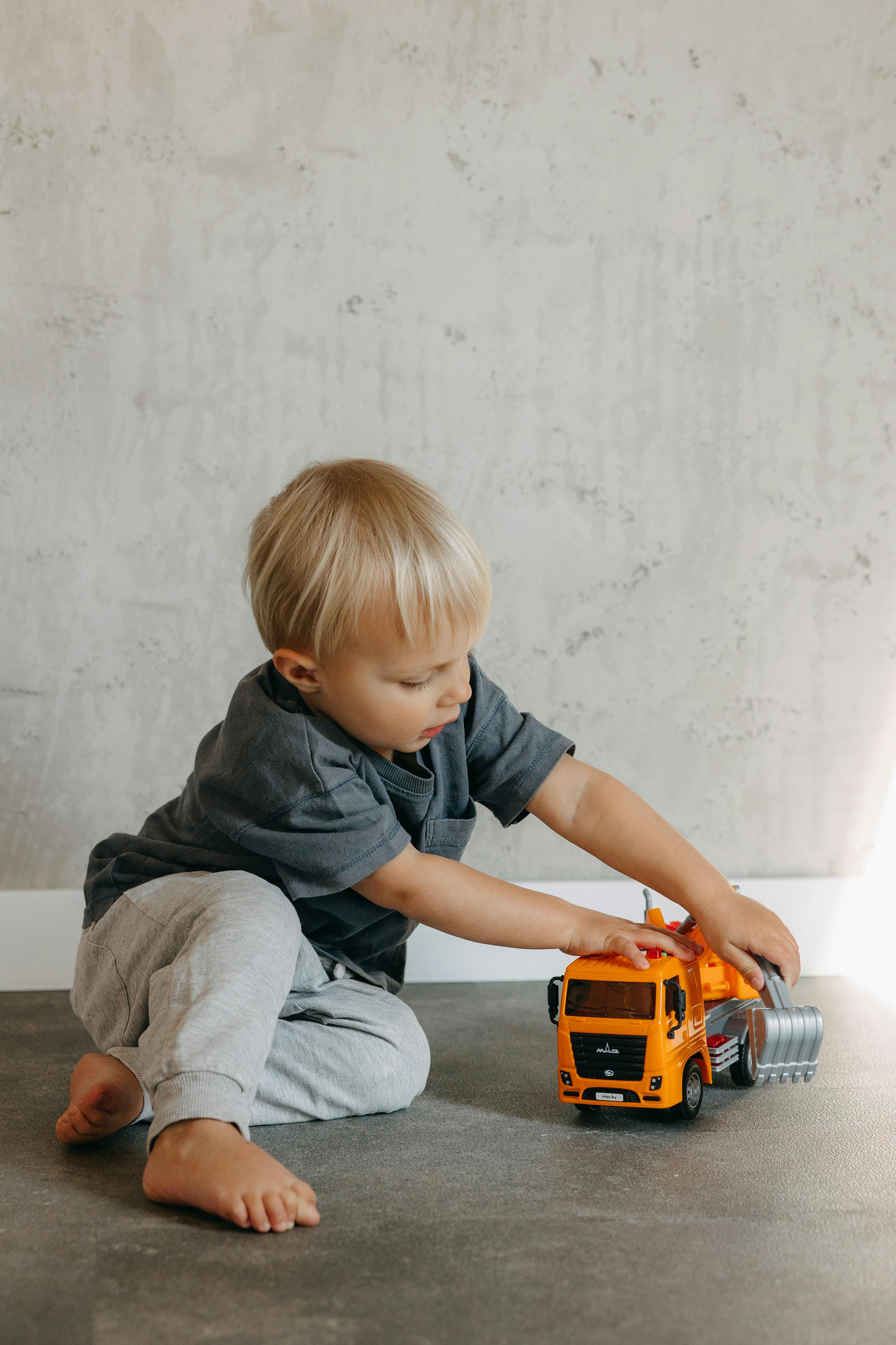 boy sitting and playing with toy