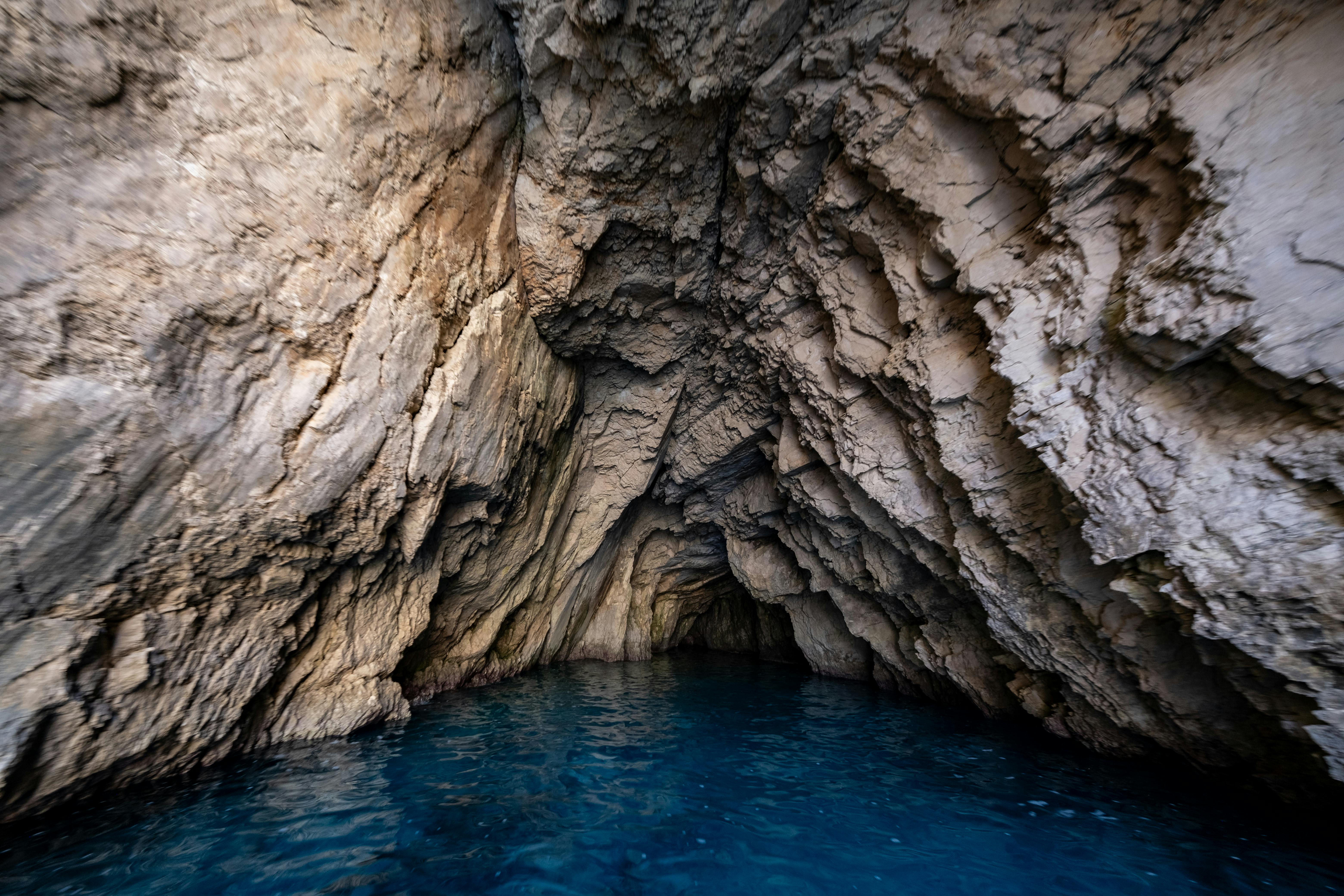 a cave with blue water inside it