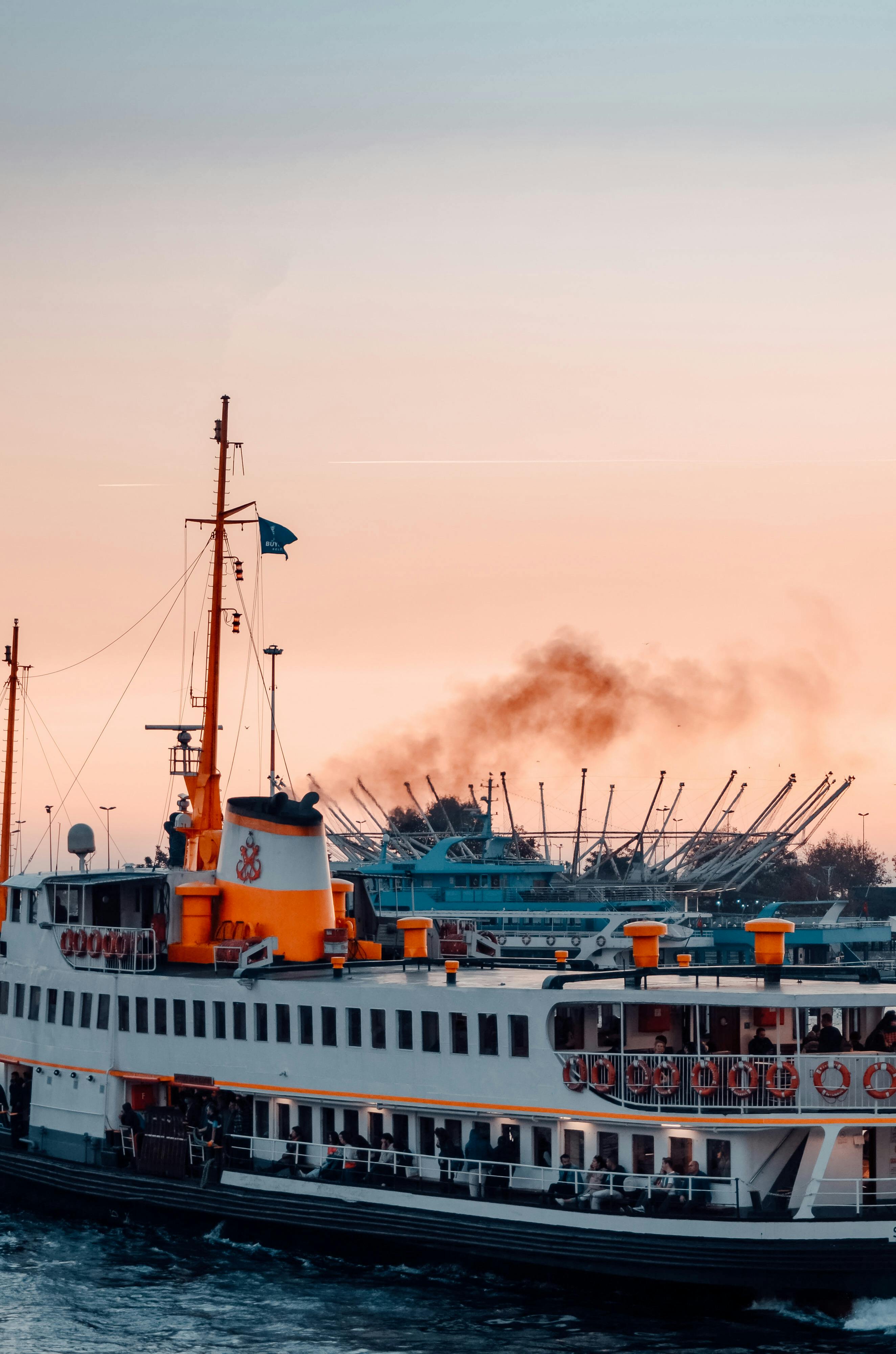 a ferry boat is docked at a dock at sunset