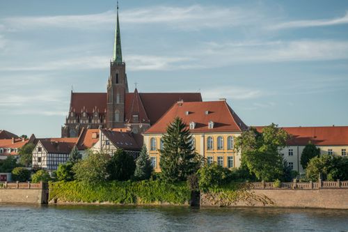 Free Scenic view of Wrocław's historic architecture and river on a summer day. Stock Photo