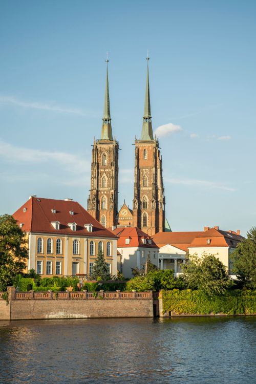 Free Stunning view of a gothic cathedral in Wrocław, Poland by the river on a sunny day. Stock Photo