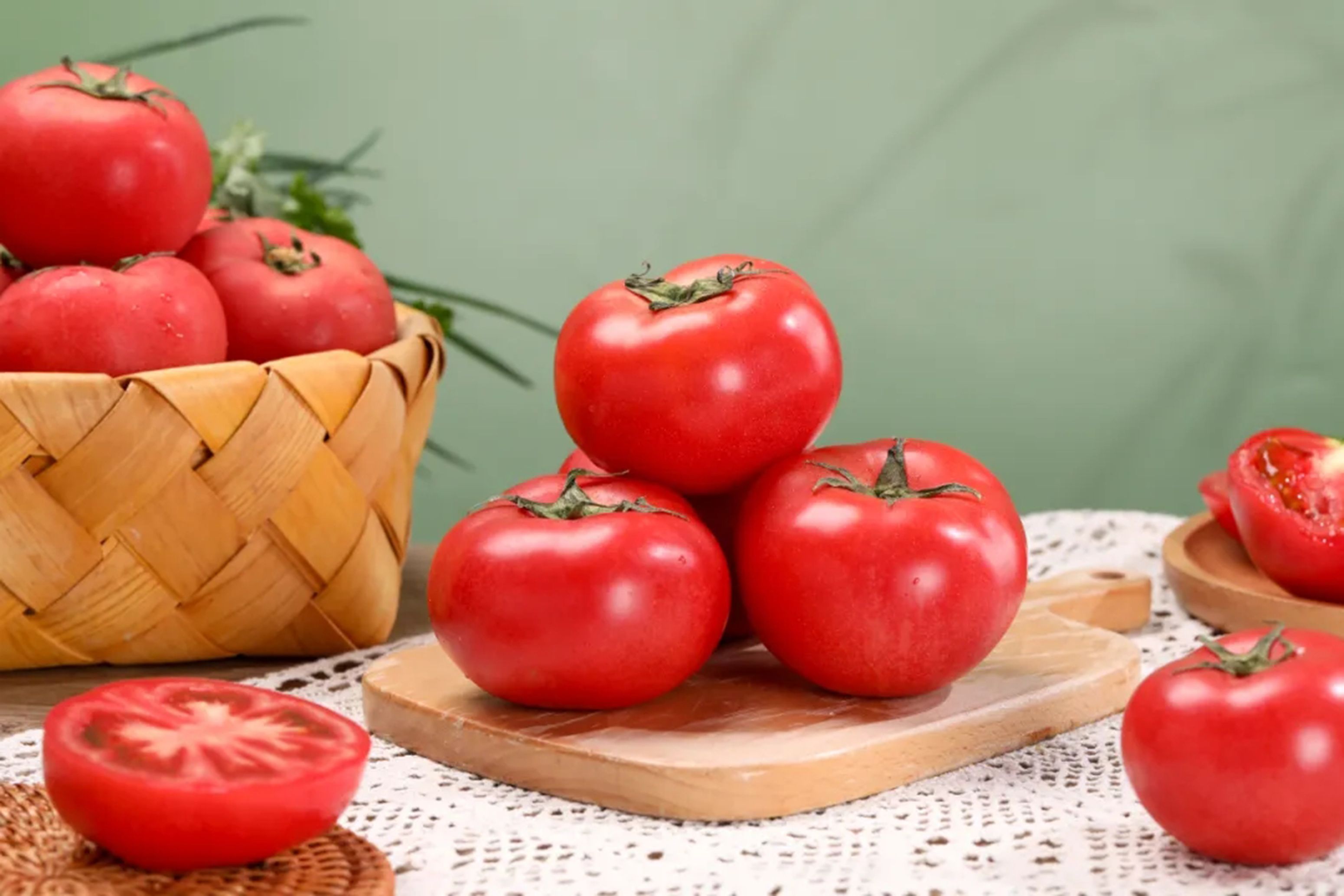 Vibrant red tomatoes arranged on a wooden cutting board, perfect for cooking and healthy eating.