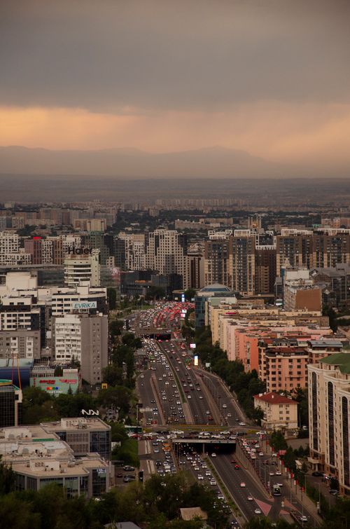 Free Stunning aerial view of Almaty cityscape with busy roads and skyline at dusk. Stock Photo