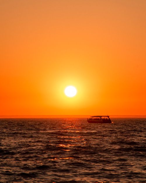 Free Captivating sunset scene with a boat on the Caspian Sea in Aktau, Kazakhstan. Stock Photo