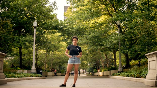 Confident young woman posing outdoors in a vibrant park setting in Chicago.