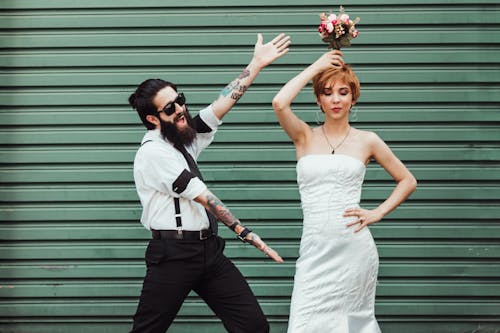 Photo of Couple Posing Near Roller Shutter