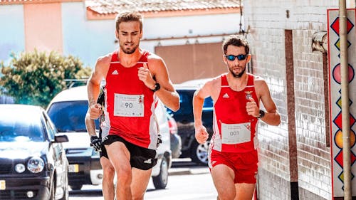 Men Running on Street Near Vehicles