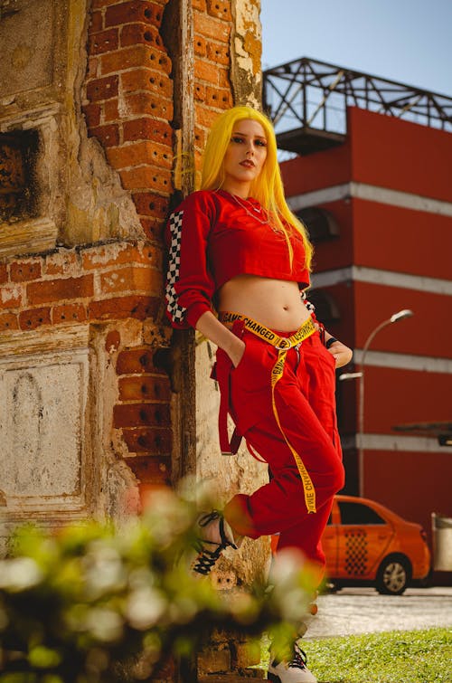 Woman Leaning on Brick Wall