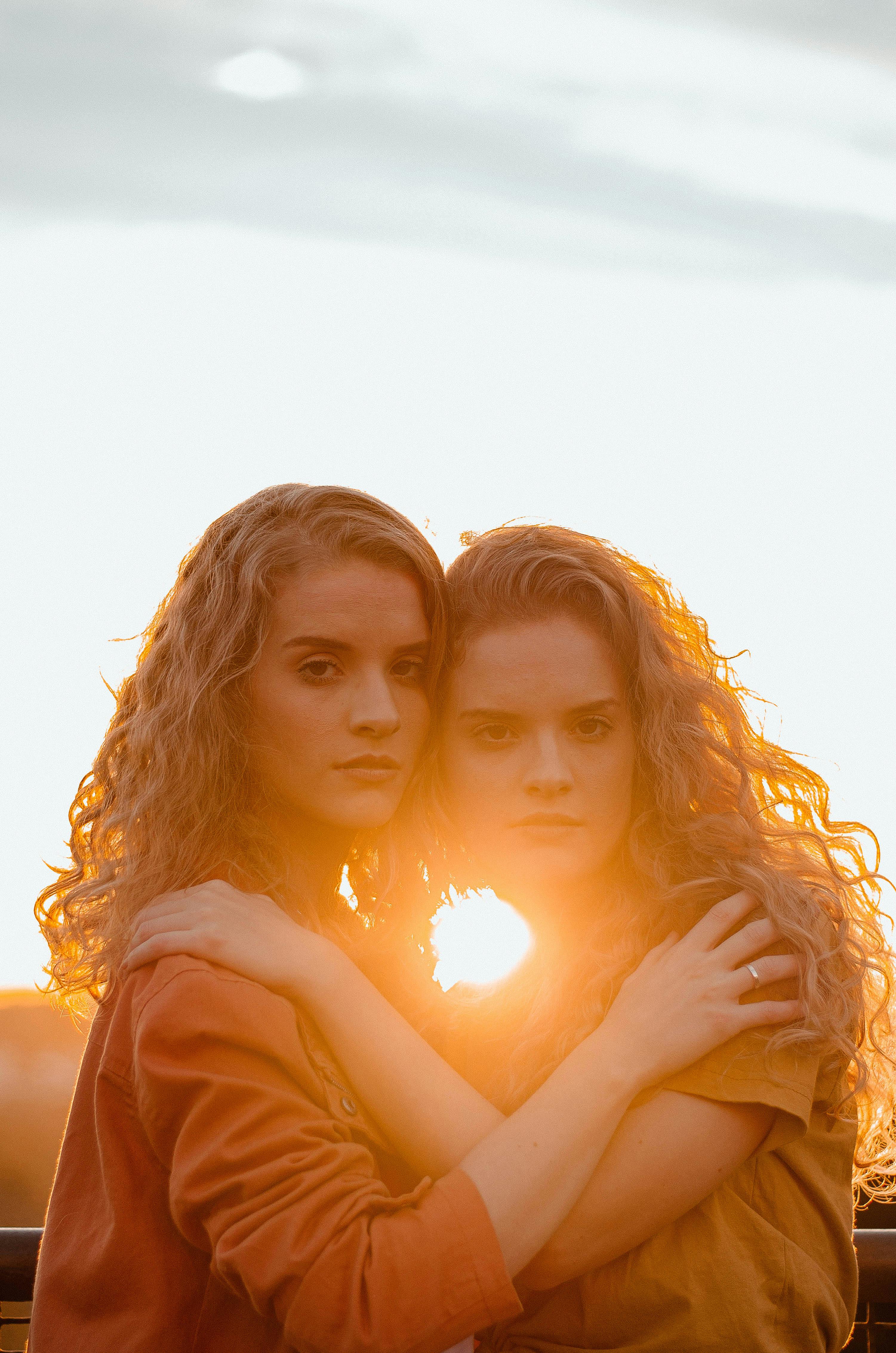 Two Women Holding Each Other Across Sunset \u00b7 Free Stock Photo