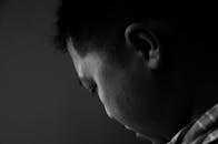 在工作室环境中拍摄的一个男人的黑白侧面肖像，他显得深思熟虑