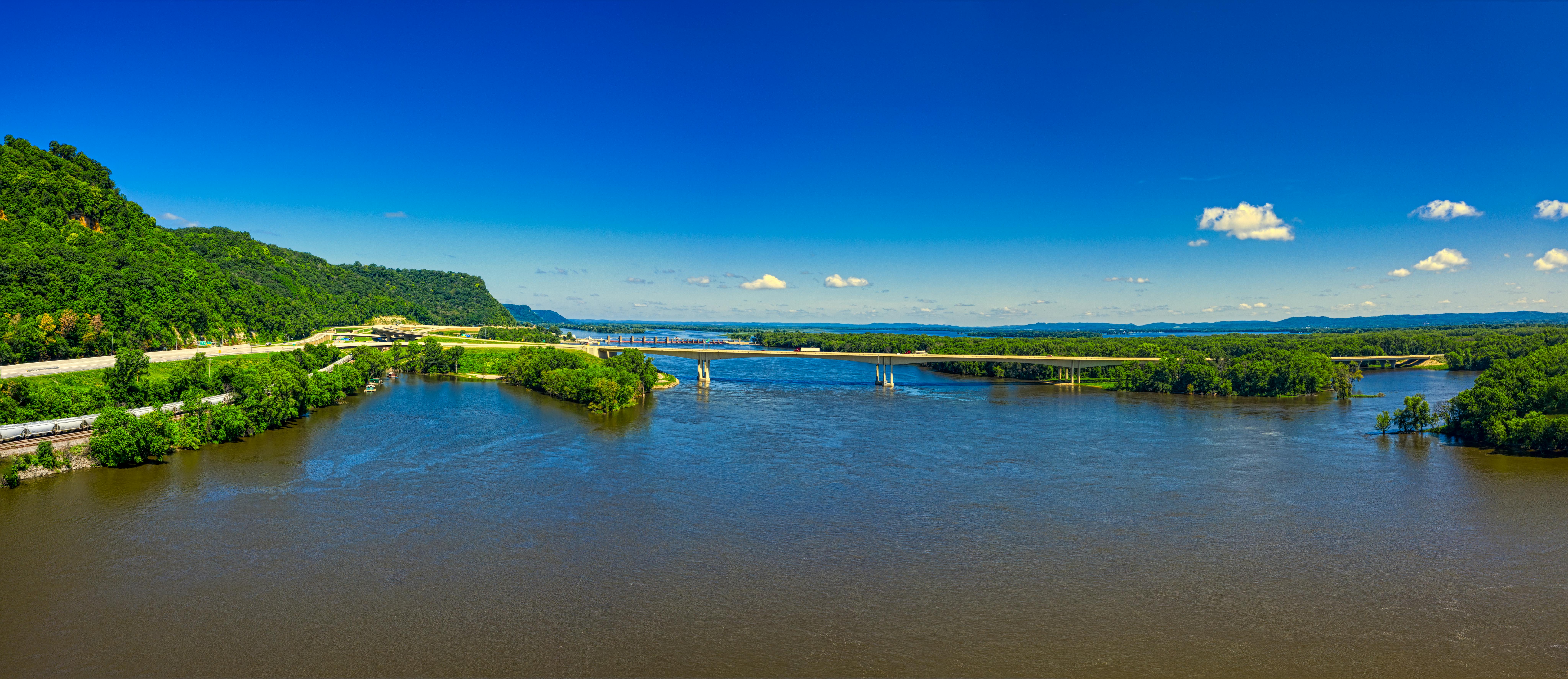 river with a bridge under blue sky