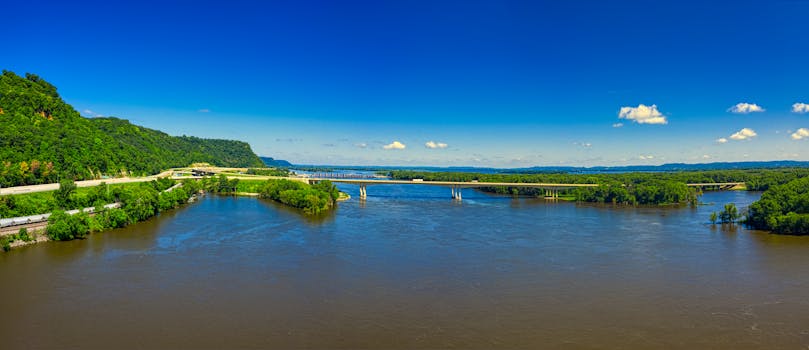 Breathtaking aerial view of the Mississippi River and bridge near La Crescent, MN, in vibrant summer colors.