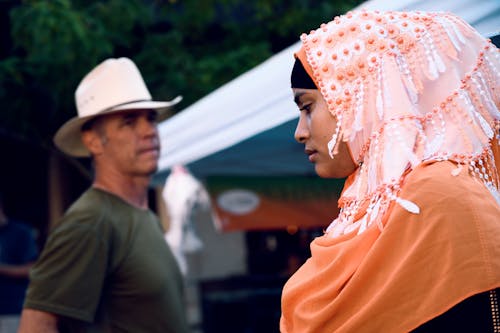 Man Wearing Cowboy Hat Looking At A Woman
