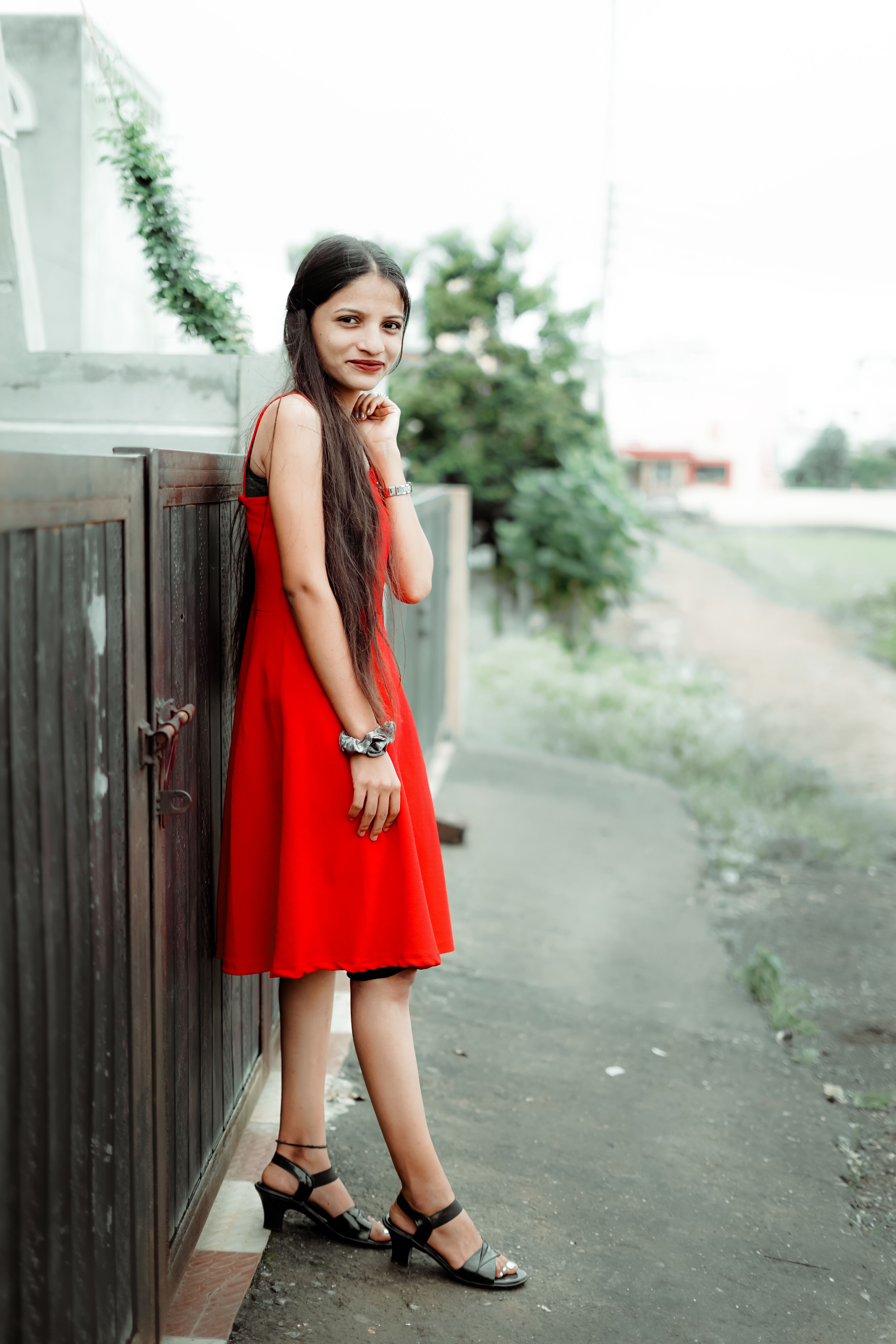 A girl in a red dress posing for a picture · Free Stock Photo
