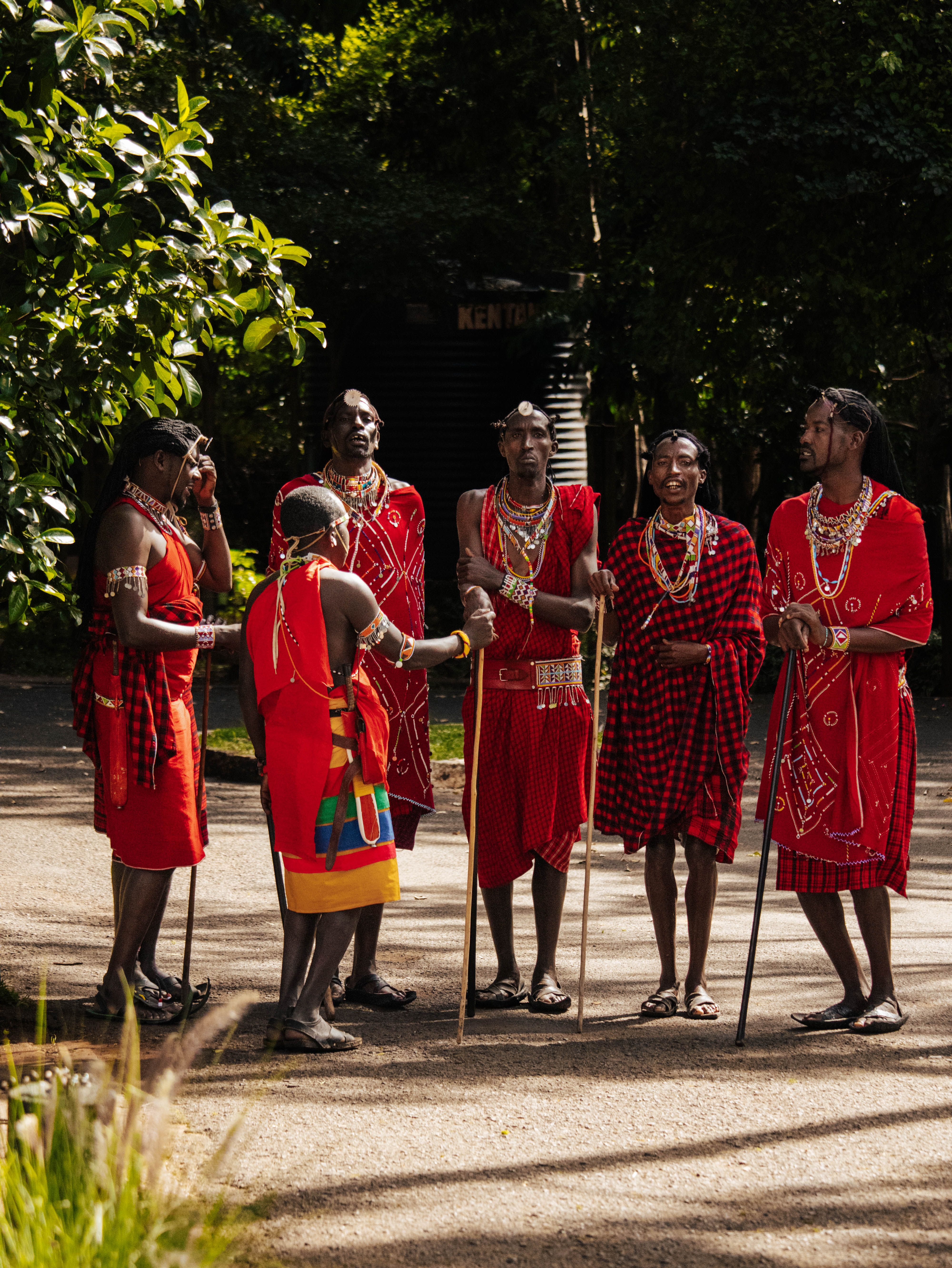 Group of Maasai men in traditional attire engaging in cultural dance in Nairobi, Kenya.