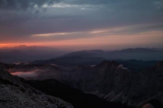 Majestic view of sunrise over mountains and mist in Slovenia, capturing tranquil nature and serene landscapes.