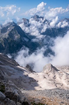 Majestic mountains and clouds in Slovenia’s Julian Alps, captured in stunning daylight.