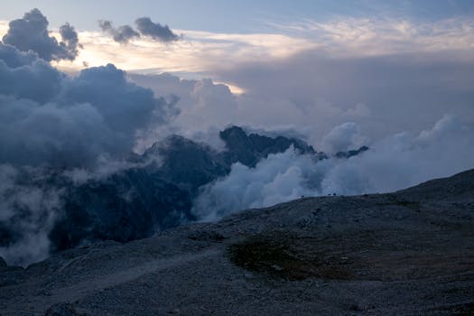 Breathtaking view of mountains above clouds at sunrise, showcasing nature's grandeur.