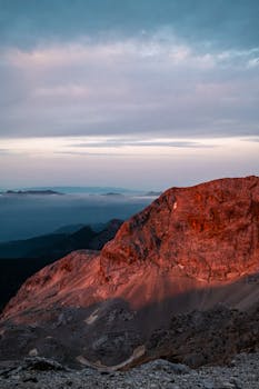 Stunning sunset view of a mountain with vibrant colors in Radovljica, Slovenia, showcasing natural beauty.