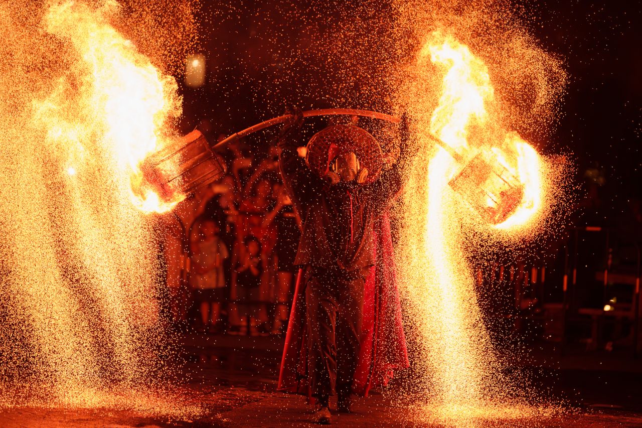 mesmerizing night time fire performance with dramatic light and sparks