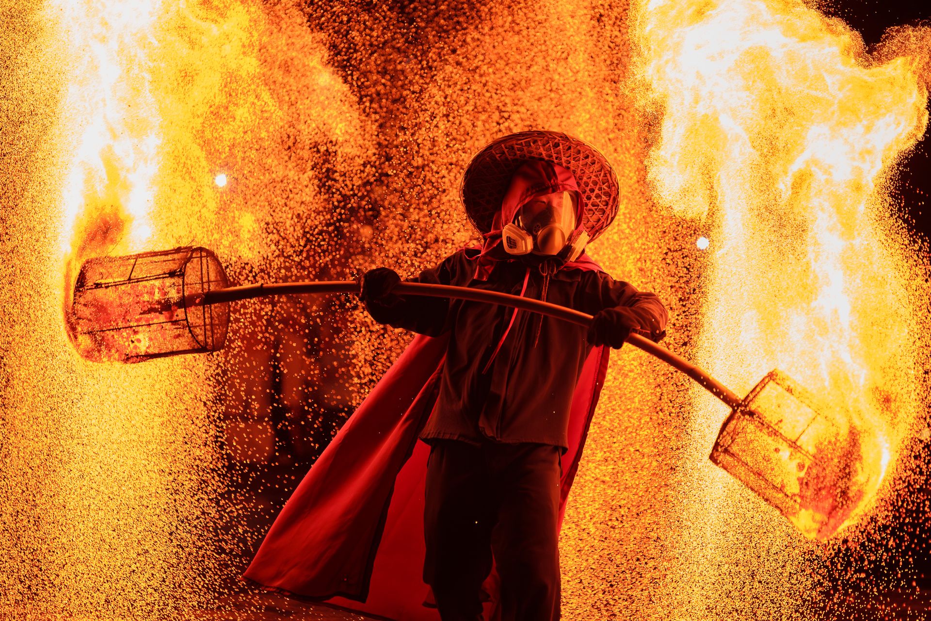 Person in Hat in Fire Performance at Night