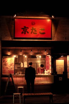 An adult male at a Japanese street food stall in Tochigi, Japan at night.