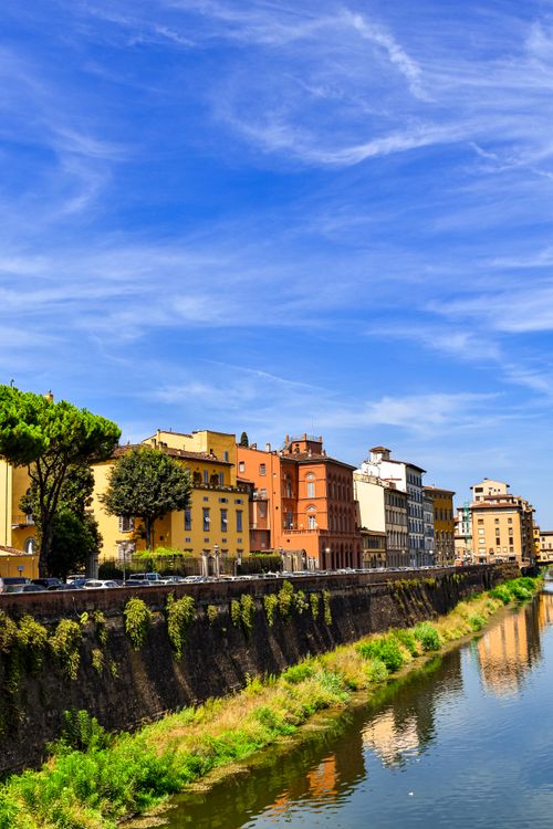 Free Colorful buildings along the Arno River in Florence on a sunny day. Stock Photo