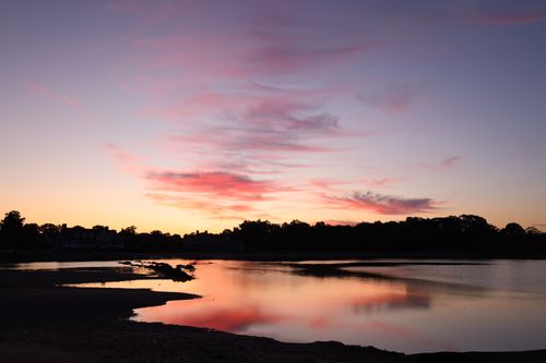 Free Serene twilight view with pink skies and reflections at Stamford beach. Stock Photo