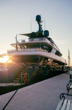 A stunning luxury yacht docked at sunset in Mali Lošinj marina, Croatia.