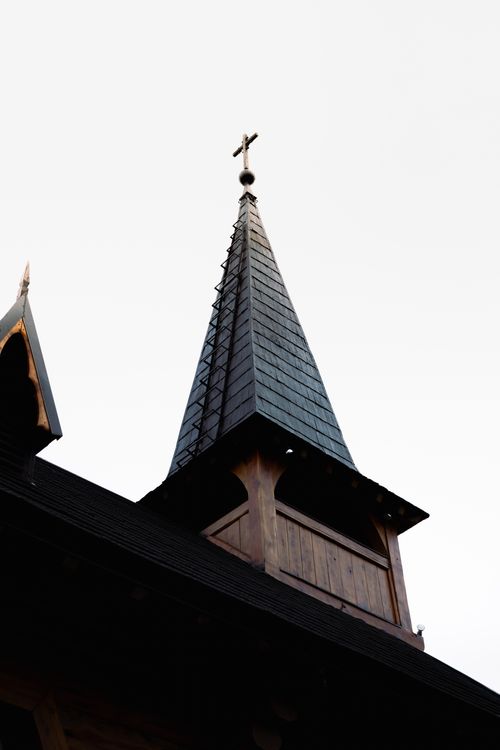 Free A Gothic-style church steeple photographed against the sunset sky in Bariloche, Argentina. Stock Photo