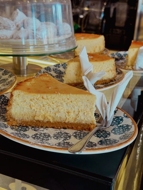 Free Close-up of a luscious cheesecake slice on a patterned plate, perfect for dessert. Stock Photo