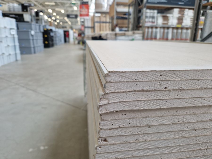 Stacked plasterboard sheets inside a Queensland building-supplies trade warehouse