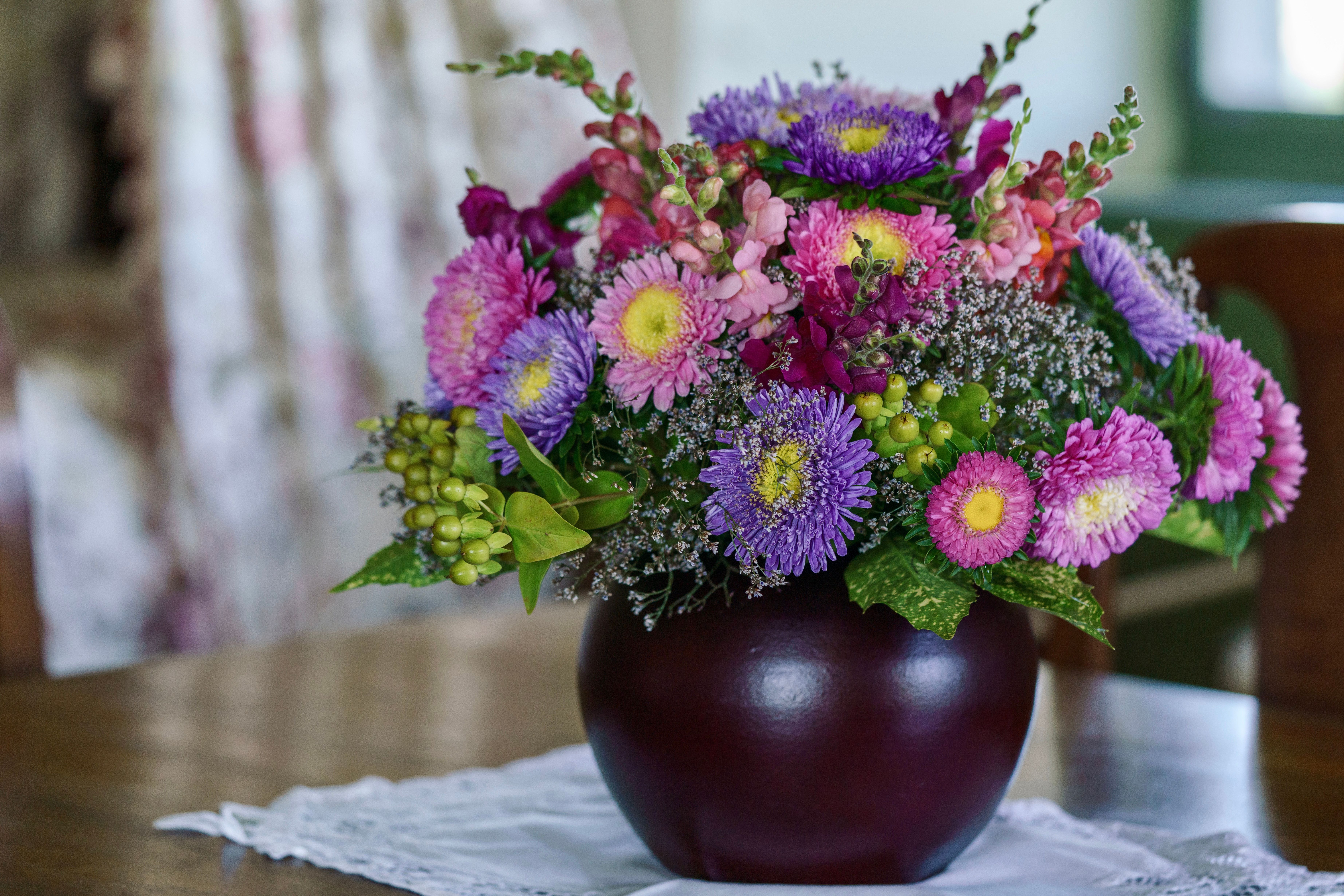 A purple and pink flower arrangement in a vase · Free Stock Photo